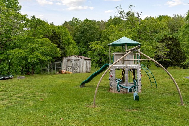 1841 SW Jones Chapel Rd, Byrdstown, TN 38549 - view of play area featuring a trampoline, a storage unit, a lawn, and an outbuilding