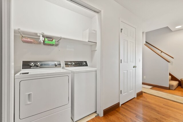 1841 SW Jones Chapel Rd, Byrdstown, TN 38549 - clothes washing area with washer and dryer, light wood finished floors, and baseboards