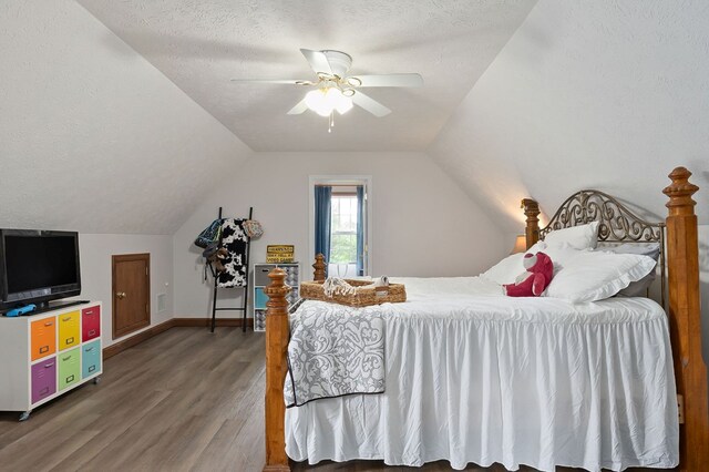 1841 SW Jones Chapel Rd, Byrdstown, TN 38549 - bedroom with wood finished floors, vaulted ceiling, a textured ceiling, baseboards, and a ceiling fan