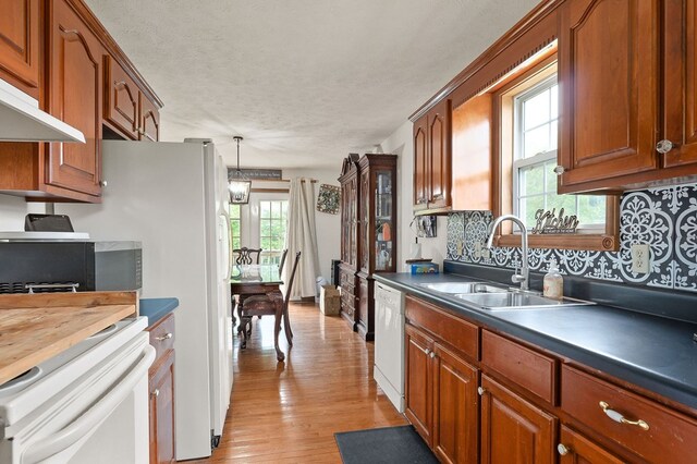 1841 SW Jones Chapel Rd, Byrdstown, TN 38549 - kitchen featuring a sink, dishwasher, stove, decorative backsplash, and brown cabinetry