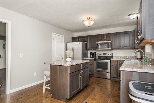 139 Rachelle Pl, Baxter, TN 38544 - kitchen featuring stainless steel appliances, dark wood-type flooring, a kitchen breakfast bar, and dark brown cabinetry