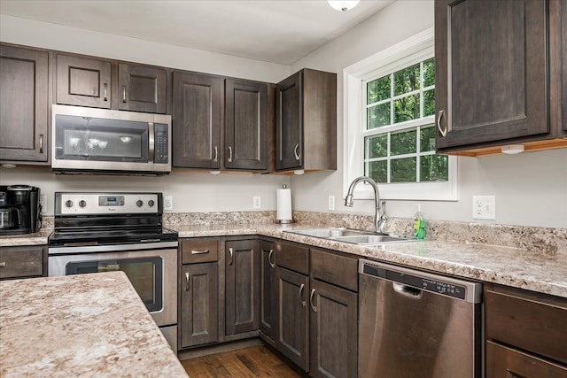 139 Rachelle Pl, Baxter, TN 38544 - kitchen with appliances with stainless steel finishes, dark brown cabinets, light countertops, and dark wood-type flooring