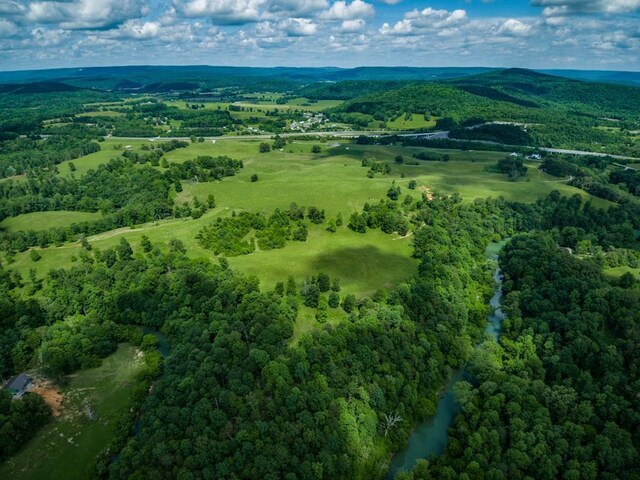 drone / aerial view with a water and mountain view