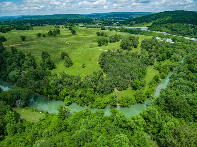 aerial view featuring a water view and a wooded view