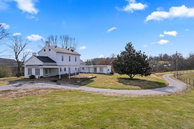 exterior space with a lawn and a chimney