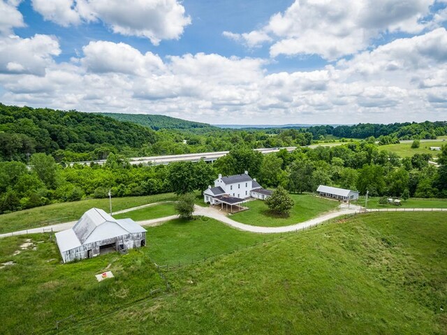 birds eye view of property featuring a view of trees