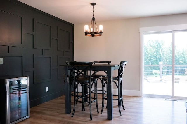 5414 Doubleview Cir, Baxter, TN 38544 - dining space with wine cooler, a chandelier, light wood finished floors, and a bar