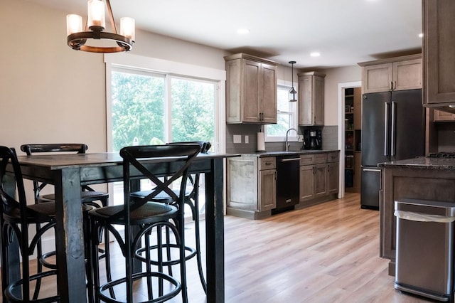 5414 Doubleview Cir, Baxter, TN 38544 - kitchen featuring freestanding refrigerator, black dishwasher, decorative backsplash, light wood-style flooring, and recessed lighting