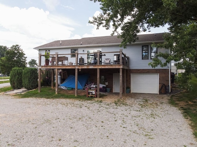 5414 Doubleview Cir, Baxter, TN 38544 - back of property with a wooden deck, an attached garage, brick siding, and driveway