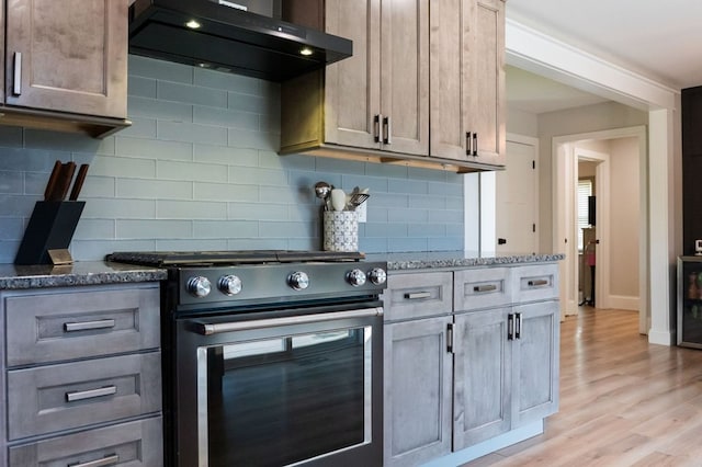 5414 Doubleview Cir, Baxter, TN 38544 - kitchen featuring stainless steel range with electric stovetop, range hood, stone counters, and decorative backsplash