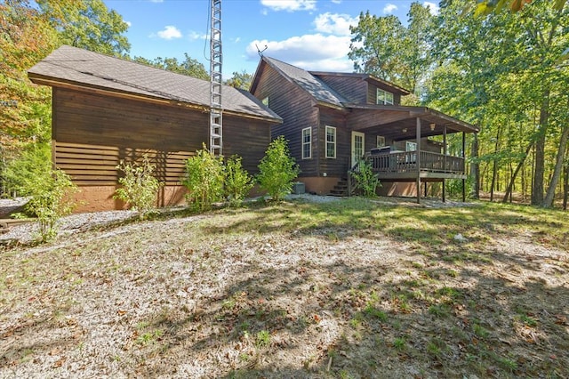 rear view of house featuring a deck