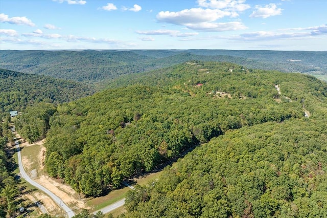 drone / aerial view featuring a view of trees