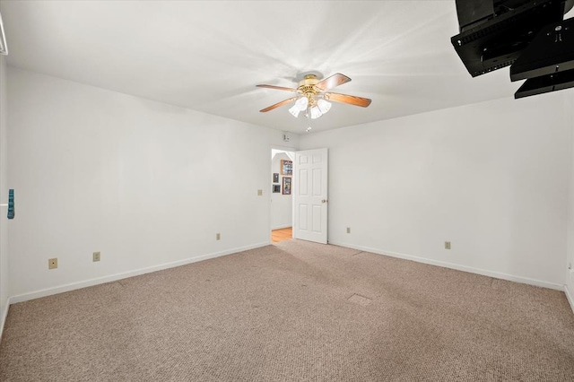 empty room featuring carpet flooring, ceiling fan, and baseboards