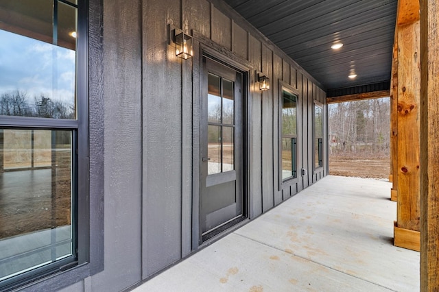 entrance to property featuring a porch and board and batten siding