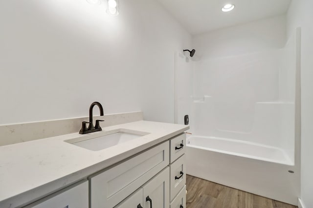 819 Hack Beaty Rd, Grimsley, TN 38565 - full bathroom with wood finished floors, vanity,  shower combination, and recessed lighting