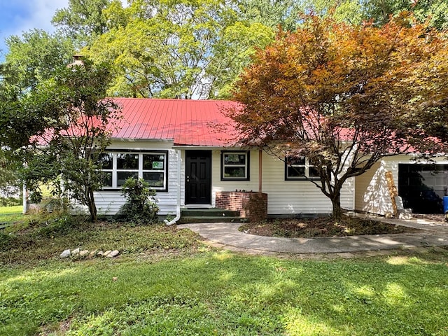 46326 US-127 S, Pikeville, TN 37367 - view of front of home featuring a front yard, a garage, and a metal roof