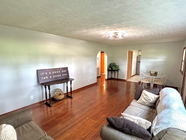 46326 US-127 S, Pikeville, TN 37367 - living room with arched walkways, wood finished floors, radiator heating unit, and a textured ceiling