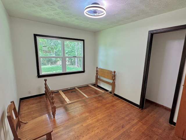 46326 US-127 S, Pikeville, TN 37367 - unfurnished bedroom featuring a textured ceiling and wood finished floors