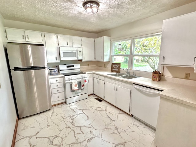 46326 US-127 S, Pikeville, TN 37367 - kitchen with white appliances, light countertops, light marble finish flooring, a textured ceiling, and white cabinets