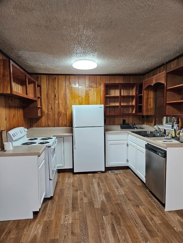 kitchen featuring white appliances, a sink, white cabinets, light countertops, and open shelves