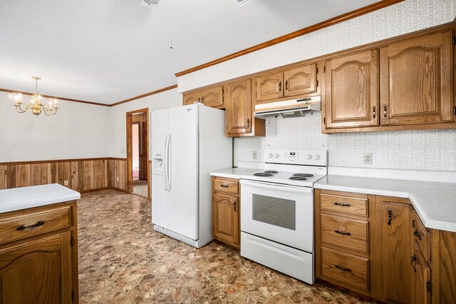 kitchen featuring under cabinet range hood, white appliances, light countertops, wainscoting, and decorative light fixtures