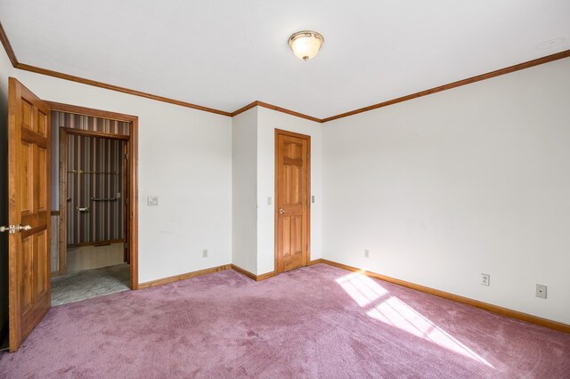 empty room featuring baseboards, ornamental molding, and light colored carpet