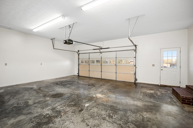 garage with baseboards and a garage door opener