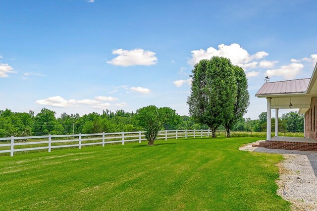 view of yard featuring a rural view and fence