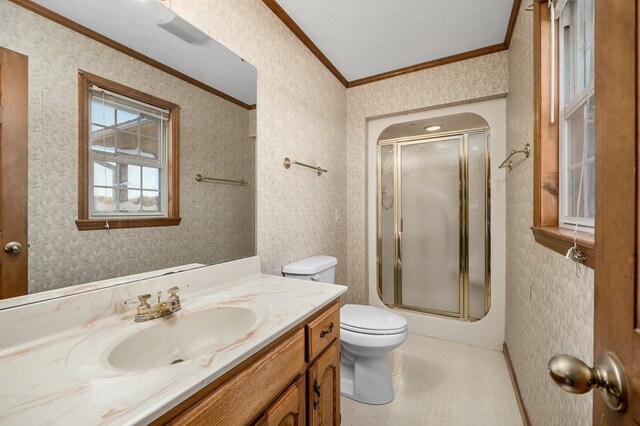 bathroom with a shower with shower door and wallpapered walls