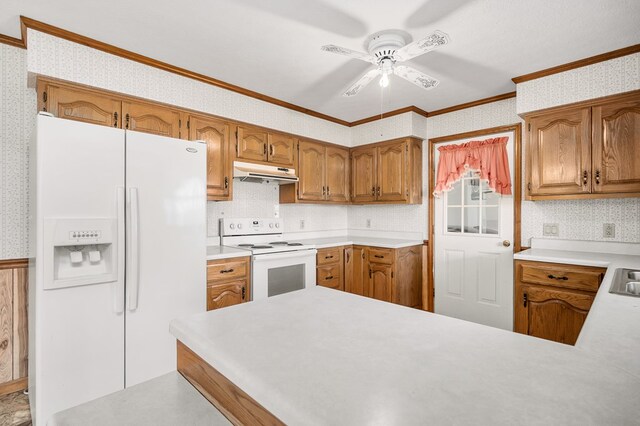 kitchen with light countertops, white appliances, under cabinet range hood, and wallpapered walls