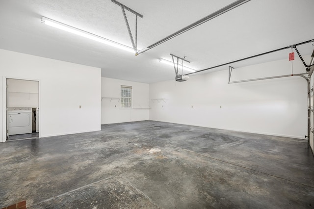 garage featuring washer and dryer and a garage door opener