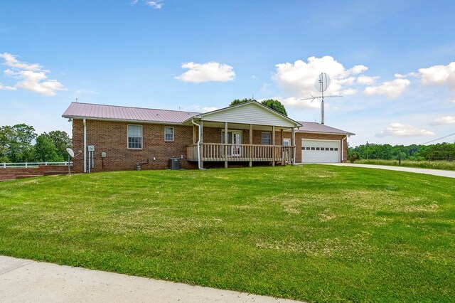 single story home with brick siding, central AC, metal roof, a garage, and a front lawn