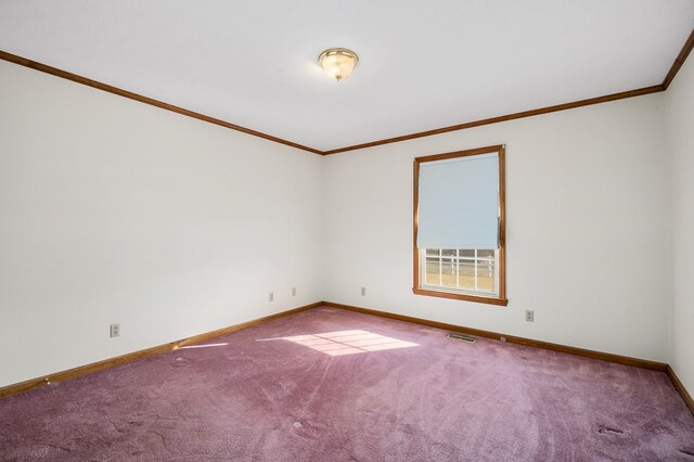 empty room with carpet floors, visible vents, ornamental molding, and baseboards