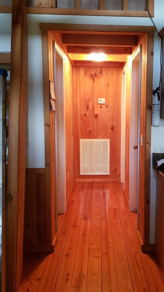 349 Treva Ln, Monterey, TN 38574 - corridor featuring light wood finished floors and wood walls