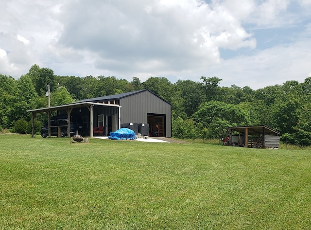 349 Treva Ln, Monterey, TN 38574 - view of grassy yard with an outbuilding, a garage, and a view of trees