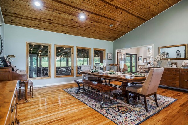 dining space with light wood-style floors, recessed lighting, wooden ceiling, and high vaulted ceiling