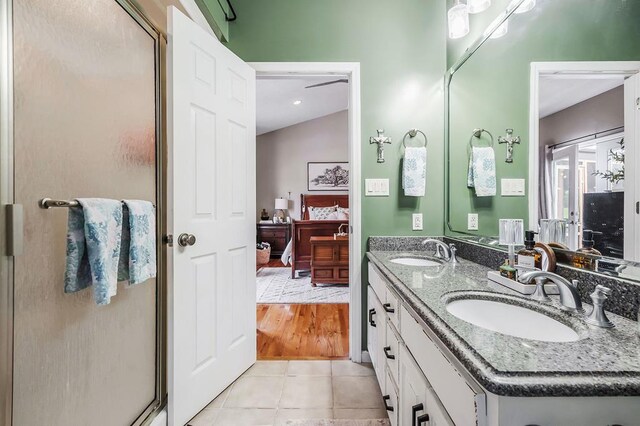 bathroom featuring a stall shower, tile patterned floors, a sink, and ensuite bathroom