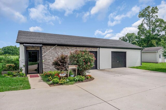 view of front of house with driveway, brick siding, an attached garage, and roof with shingles