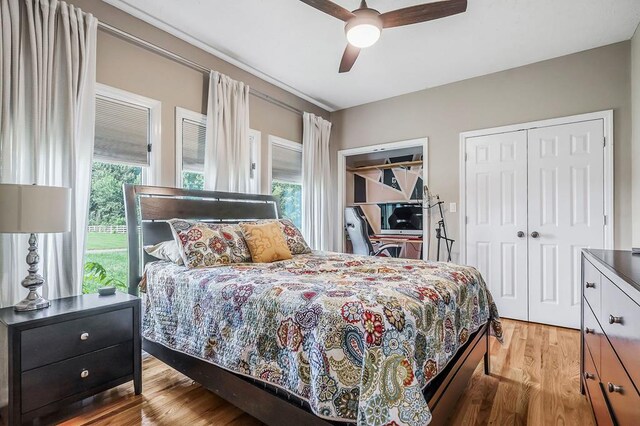 bedroom featuring light wood finished floors, a closet, and a ceiling fan