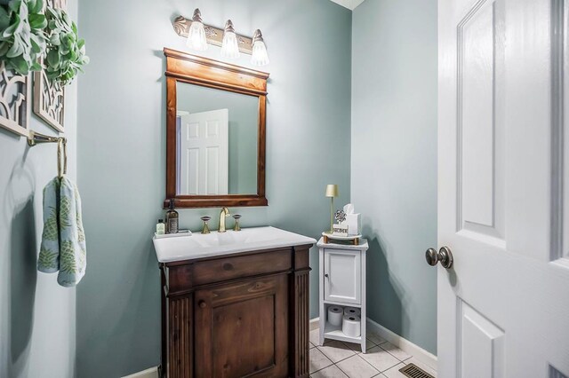 bathroom with tile patterned flooring, visible vents, baseboards, and vanity