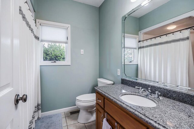 full bath with vanity, tile patterned flooring, toilet, and baseboards