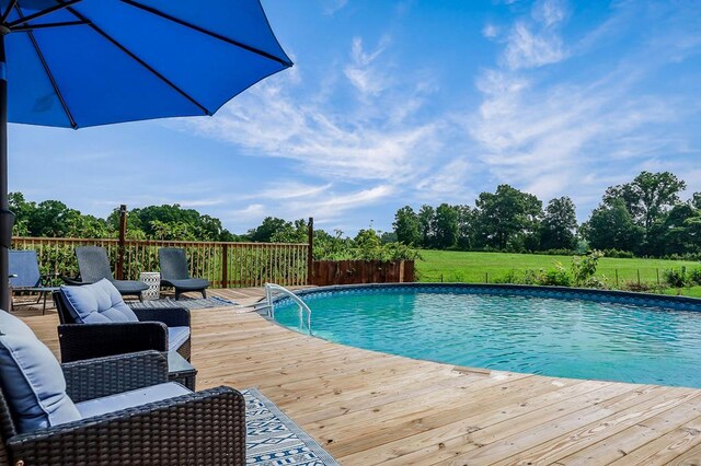 view of pool featuring fence, a deck, and a fenced in pool