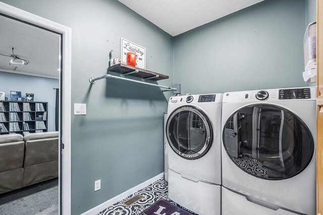 laundry area featuring washer and dryer, laundry area, and baseboards