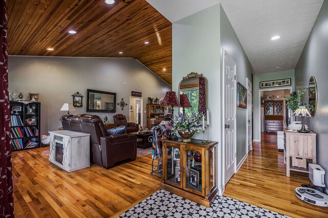 interior space with wood ceiling, vaulted ceiling, wood finished floors, and recessed lighting