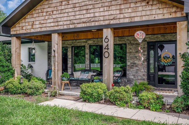 entrance to property featuring covered porch