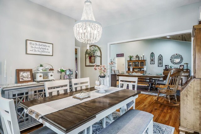 dining area featuring an inviting chandelier and wood finished floors