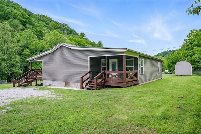 3569 Dry Mill Creek Rd, Hilham, TN 38568 - back of property featuring crawl space, stairs, a lawn, a deck, and a storage unit