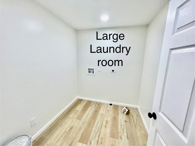 laundry area with laundry area, baseboards, wood finished floors, hookup for a washing machine, and hookup for an electric dryer