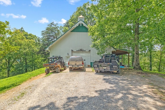 292 Mclerran Cemetery Rd, Moss, TN 38575 - view of side of property with a detached garage, driveway, and an outdoor structure