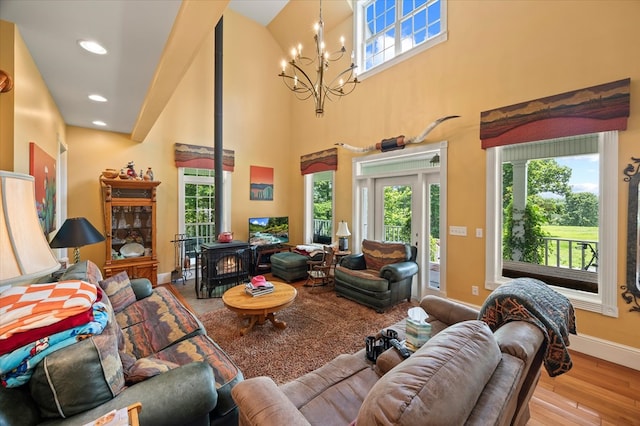 292 Mclerran Cemetery Rd, Moss, TN 38575 - living room with a wood stove, a chandelier, healthy amount of natural light, a towering ceiling, and recessed lighting